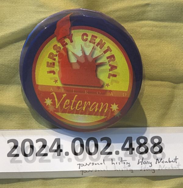 Button belonging to former JCL and CR conductor & engineer H.E. Neubert