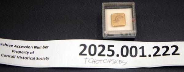 CR lapel pin in its plastic storage box