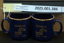 CR logo mugs, gold on blue 1976 & 1998